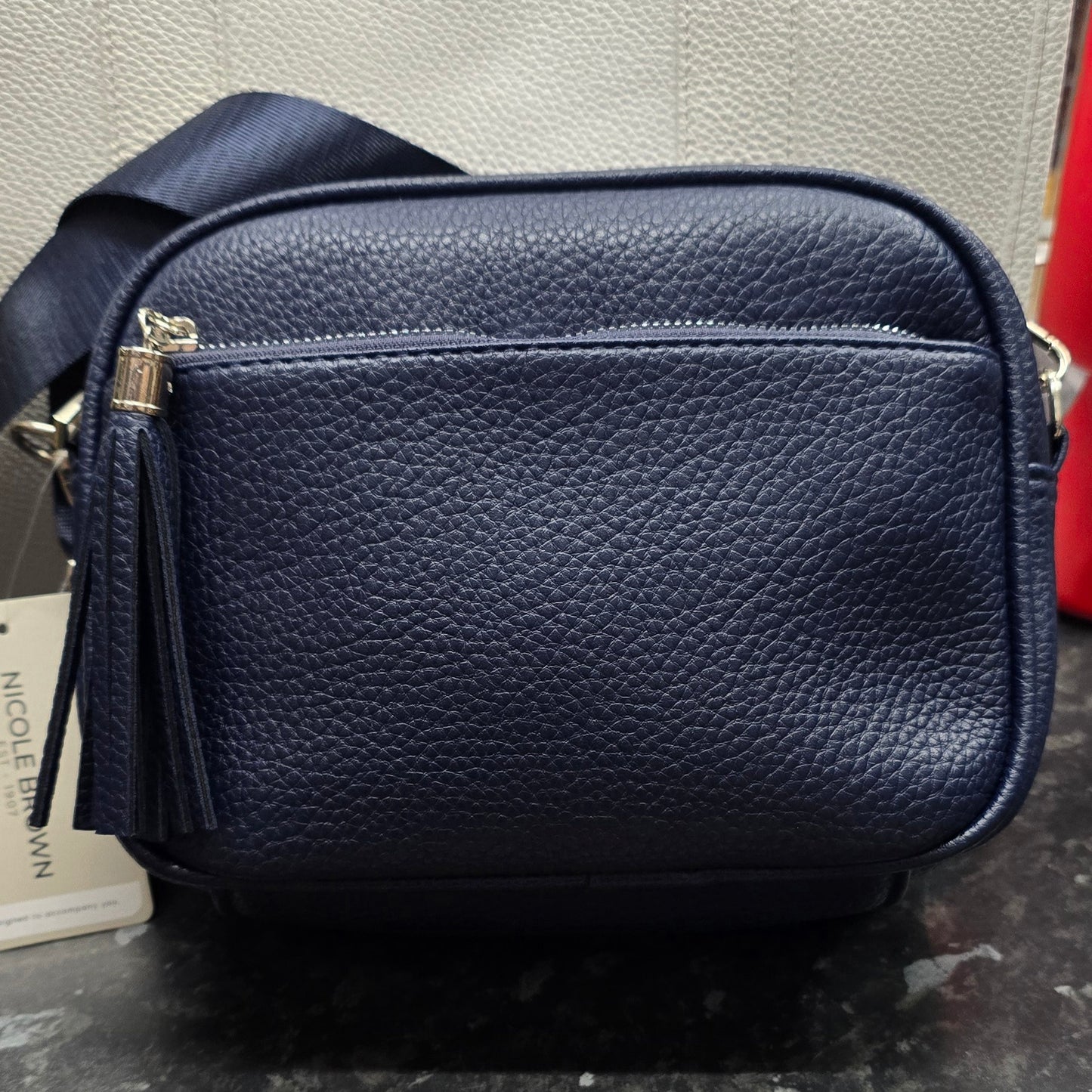 Small crosd body handbag with tassle.